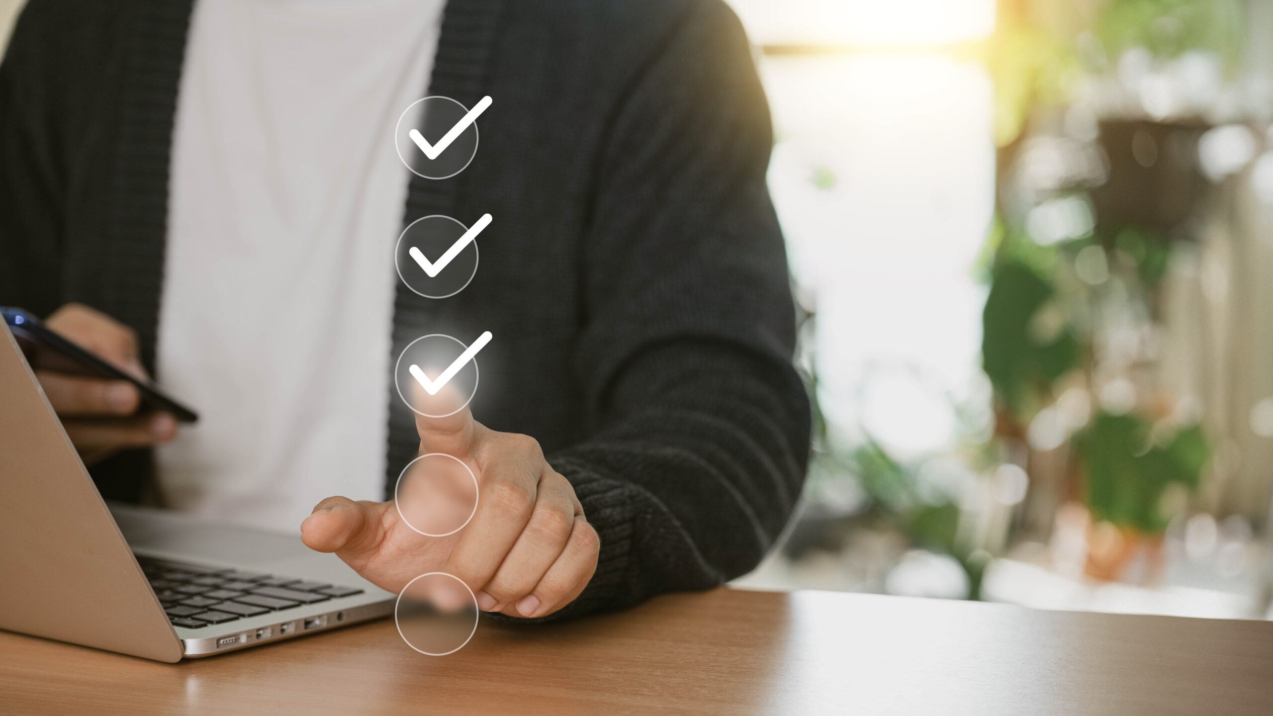 A businessman uses his laptop at home to select the appropriate